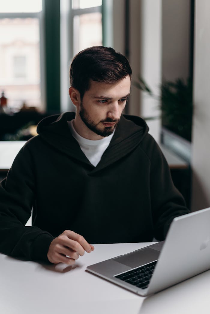 Man in Black Hoodie Using Macbook